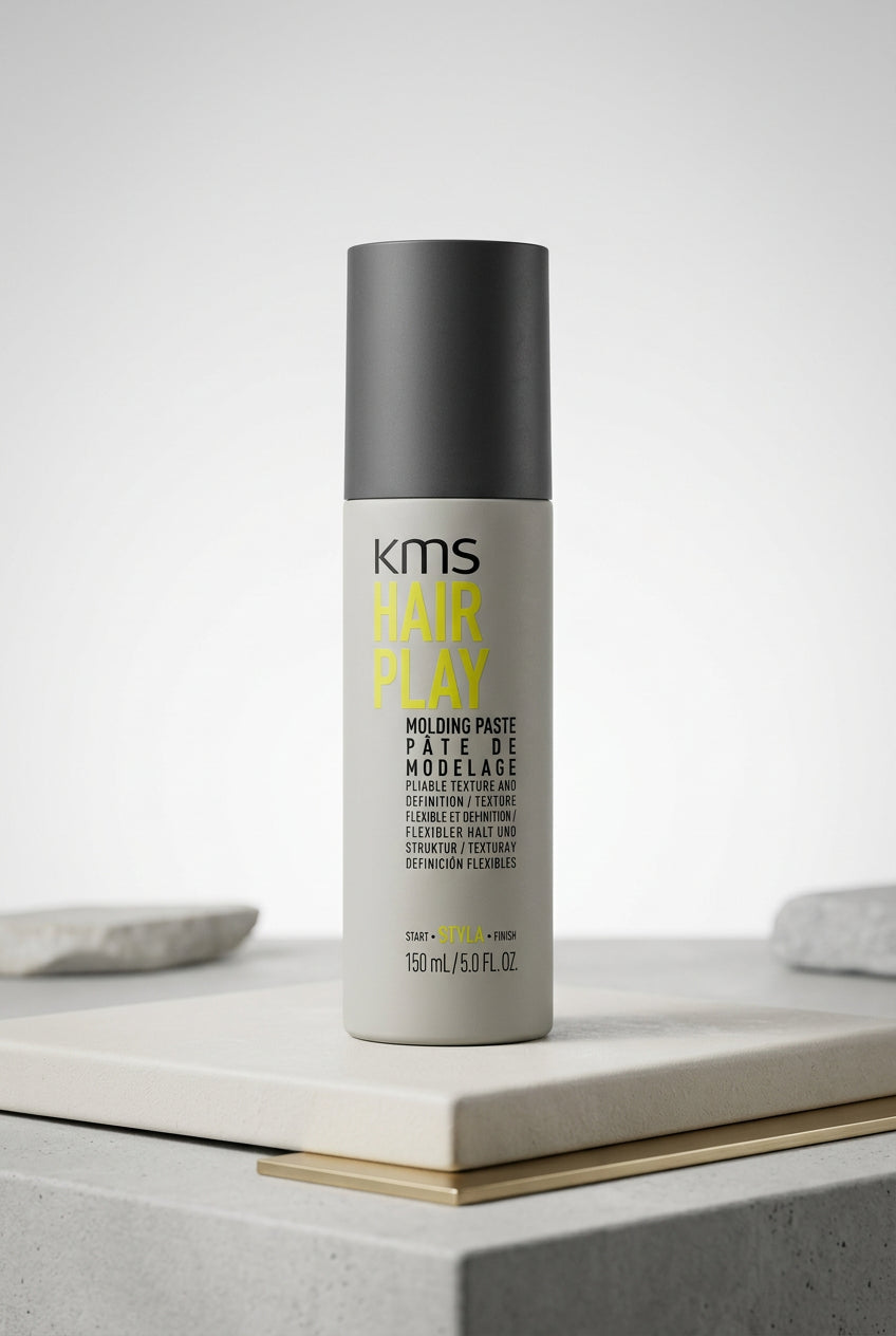 KMS Hairplay Molding Paste bottle with yellow lettering and a black cap.